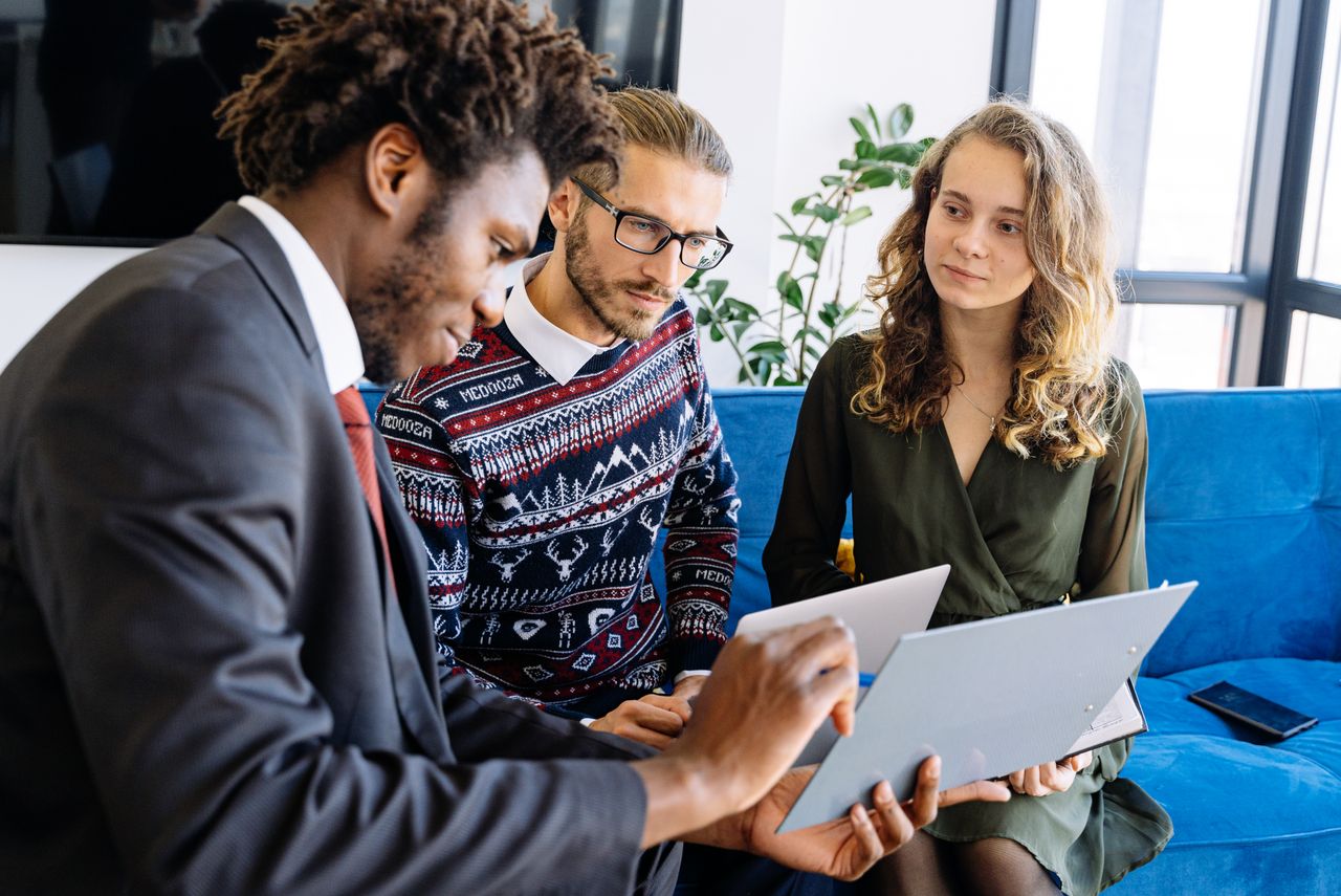 Mastering the First Impression: Your intriguing post title goes here A diverse group of young professionals engaged in a business meeting inside a modern office.