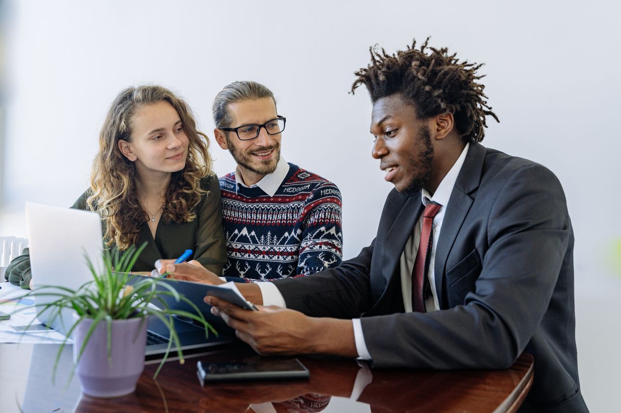 The Art of Drawing Readers In: Your attractive post title goes here A diverse group of professionals collaborating in an office meeting, showcasing teamwork and partnership.